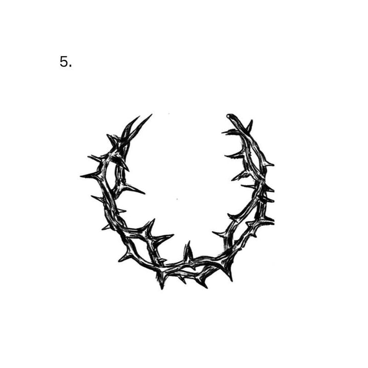 An upward-open U-shaped wreath is made from intertwined branches covered in sharp thorns.
