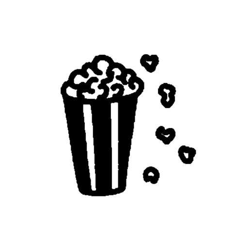 A striped popcorn bucket is filled with fluffy popcorn, with five small popcorn pieces scattered to its right.
