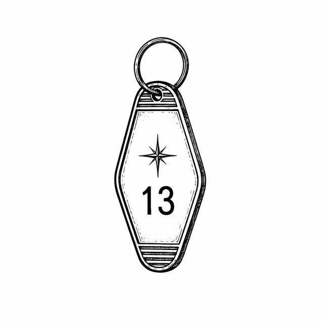 A vintage motel key tag hangs from a round ring and displays an eight-point star above the number “13”.