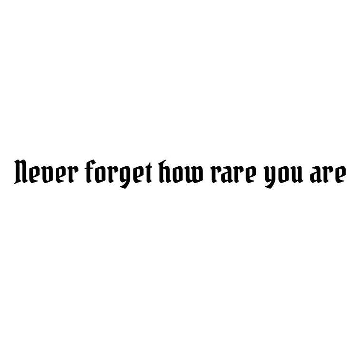Temporary tattoo reading “never forget how rare you are” in condensed gothic lettering